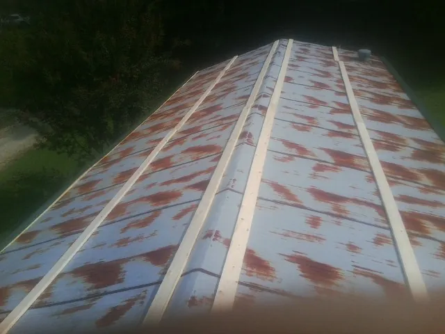 Rusted metal roof panels with new wood purlins before replacement — Storm Damage Roof Repair in Elk City by Roofing Brothers